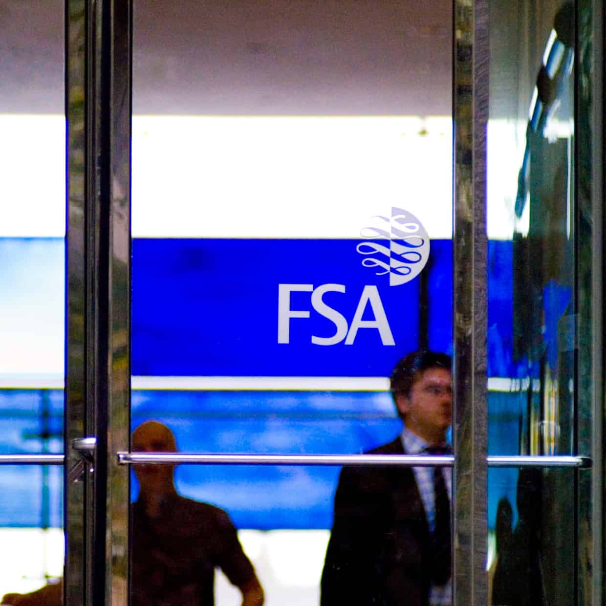 Glass entrance doors with the FSA logo and people visible inside the building.